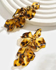 Tortoiseshell leaf-shaped earrings on a white background