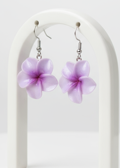 Purple flower-shaped earrings on a white arch background