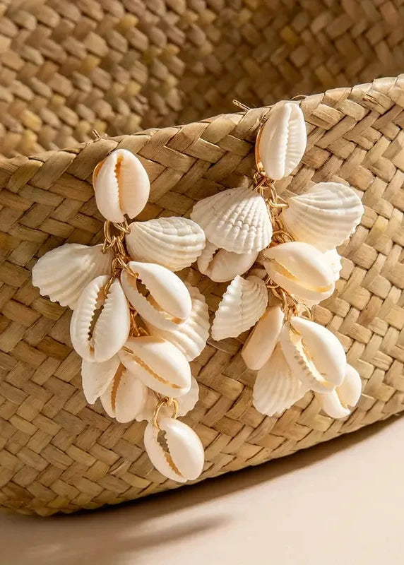 Woven basket with shell decorations on a neutral background