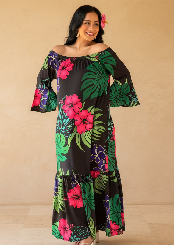 Woman wearing a colorful floral dress standing on a wooden deck with greenery in the background
