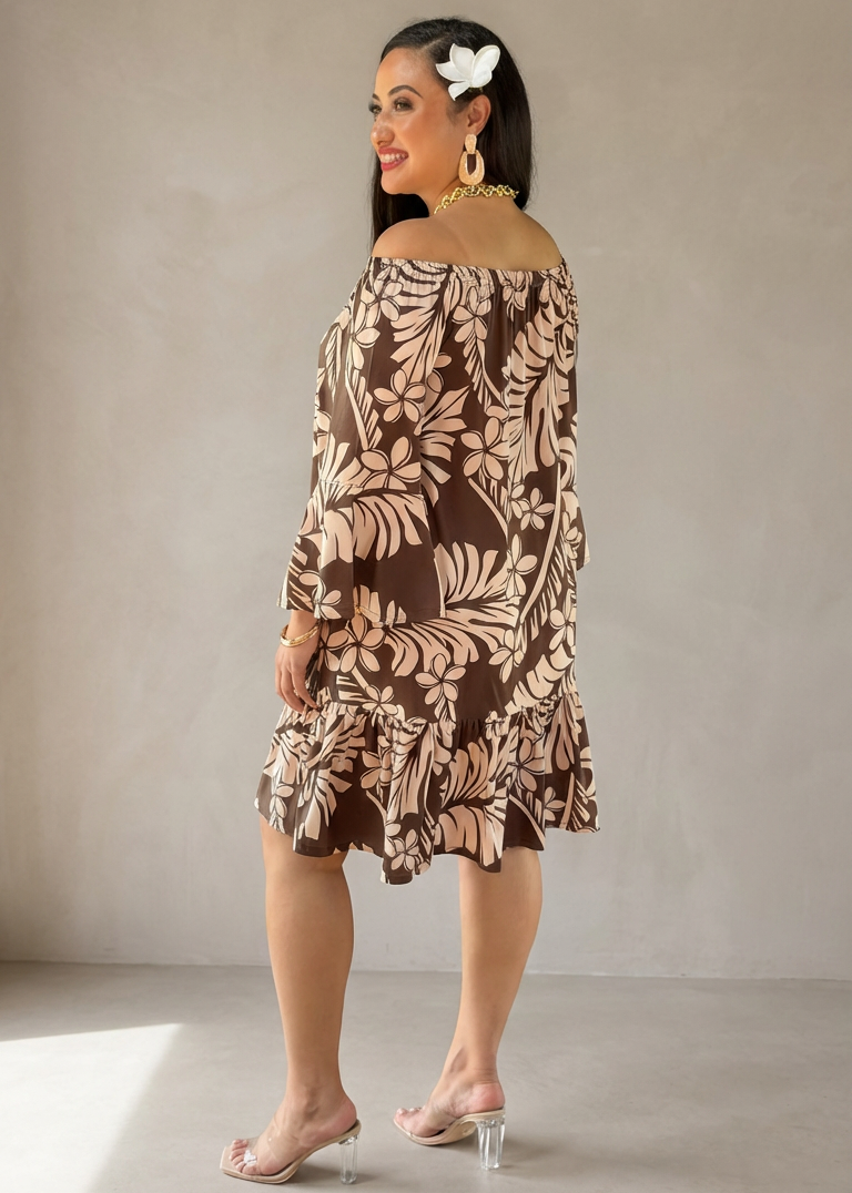 Woman wearing a patterned dress against a plain background