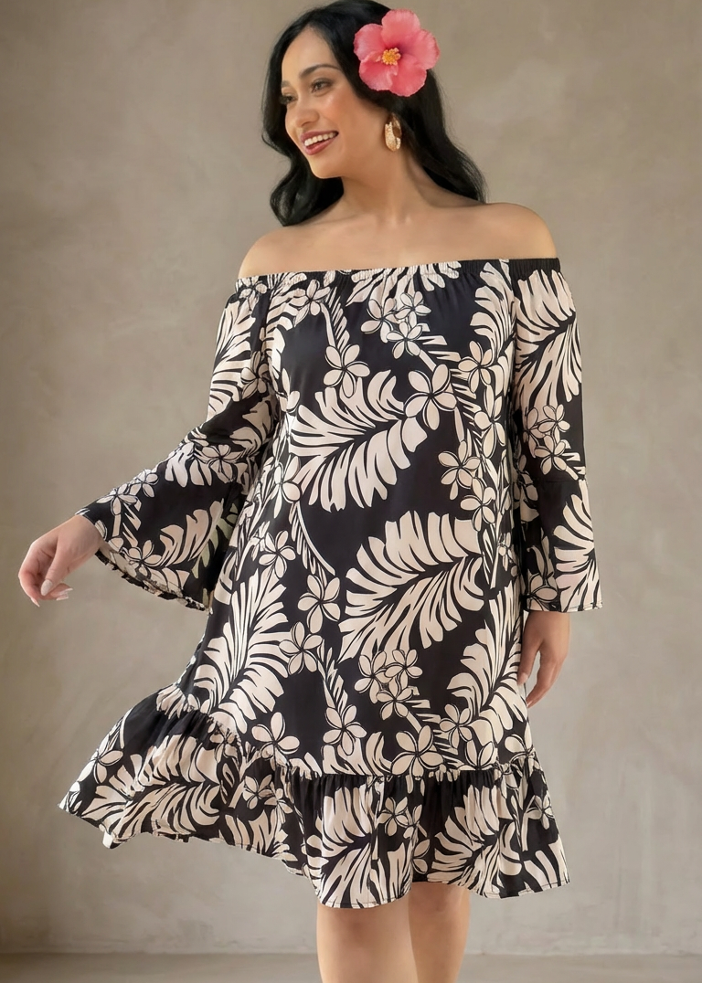 Woman wearing a black and white patterned dress against a neutral background