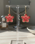 Pink flower-shaped earrings on a white background