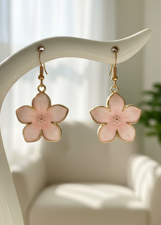 Flower-shaped earrings with gold accents on a white background