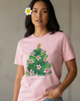 Pink t-shirt with a Christmas tree design on a textured gray background