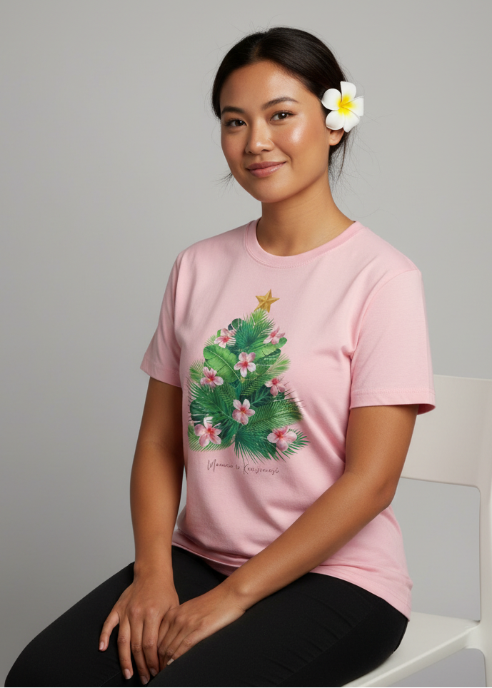 Woman wearing a pink t-shirt with a floral design, sitting on a white chair against a gray background.