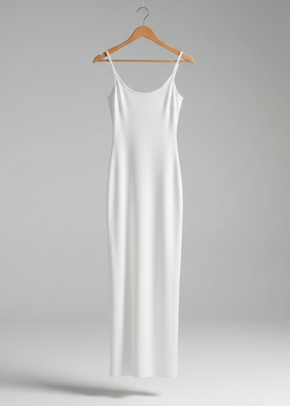 White slip dress hanging on a wooden hanger against a gray background