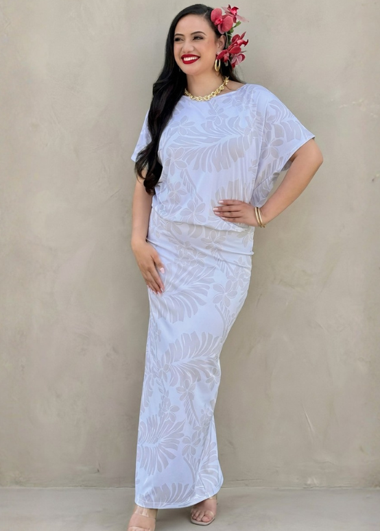 Woman wearing a white lace dress against a beige wall