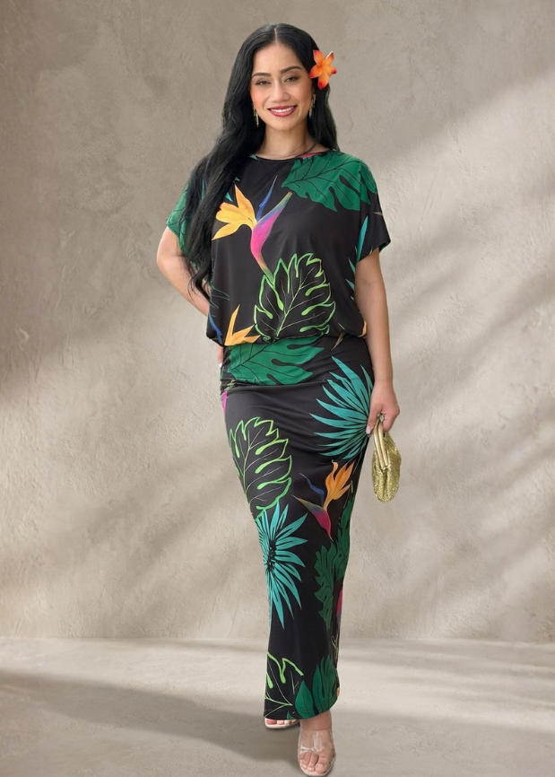 Woman wearing a colorful tropical-themed outfit against a neutral background