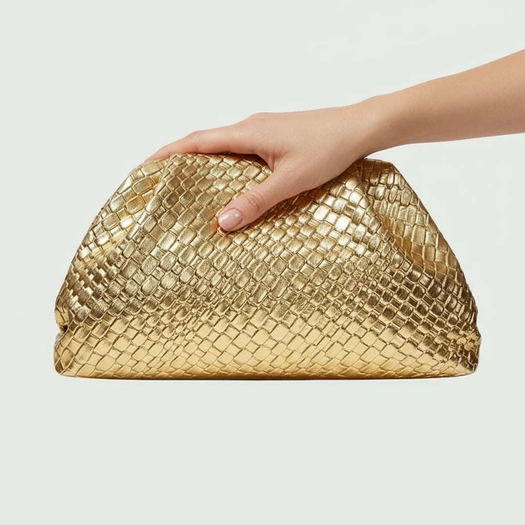Gold woven handbag on a light gray background