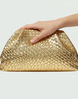 Gold woven handbag on a light gray background