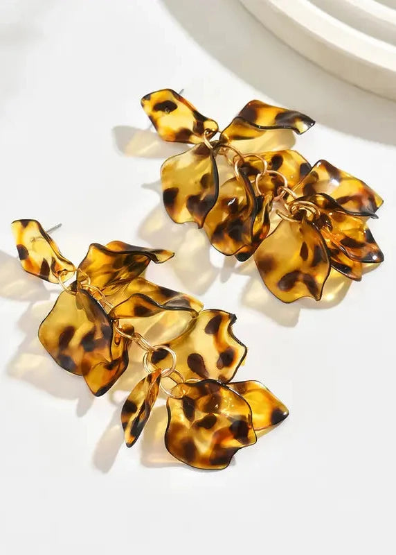 Tortoiseshell floral earrings on a white background